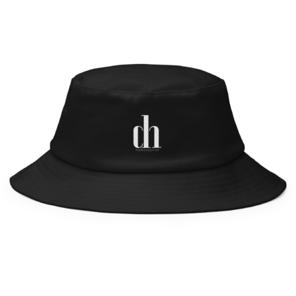 Close-up of a black bucket hat with a small white logo on the front that reads 'dlco' or similar, highlighting the fabric texture and stitching details.