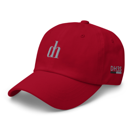 Close-up of a red baseball cap with white embroidered text on the side, set against a white background, curved brim visible.
