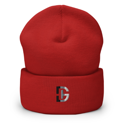 Close-up of a red knitted beanie worn on a head, showing the crown seam and a partial logo at the lower front.