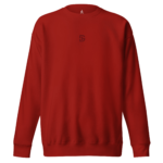 Red crewneck sweatshirt with a small dark emblem centered on the chest.