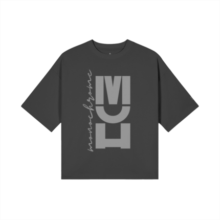 Charcoal oversized T-shirt with a tall vertical graphic of large light-gray letters and a cursive word along the left side.